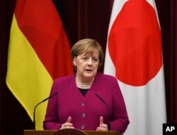 German Chancellor Angela Merkel answers a question during a joint press conference with Japanese Prime Minister Shinzo Abe following their summit meeting at Abe's official residence in Tokyo, Feb. 4, 2019.
