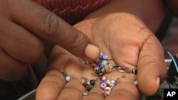 An entrepreneur sorts beads in Haiti.