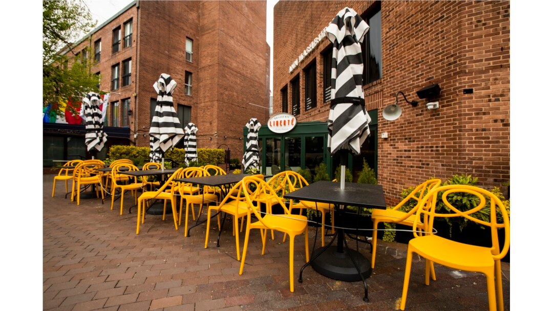 Empty chairs lines a sidewalk outside a restaurant Washington's Georgetown district, April 29, 2020. The coronavirus is sending the U.S. economy into the biggest and fastest collapse since the Great Depression, with economic output reported.