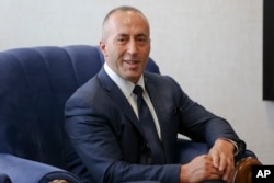 Kosovo's newly elected prime minister Ramush Haradinaj smiles during a welcoming hand over ceremony, Sept. 11, 2017, in Kosovo capital Pristina.