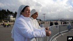 Two nuns attend a mass at the Chapel of the Apparitions in the Fatima Sanctuary, May 11, 2017.