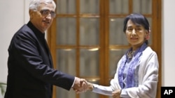 Burma opposition leader Aung San Suu Kyi, and Indian Foreign Minister Salman Khurshid pose for the media before a meeting in New Delhi, India, November 15, 2012.