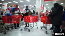 FILE - People shop inside a Target store during Black Friday sales in the Brooklyn borough of New York, Nov. 29, 2013. 