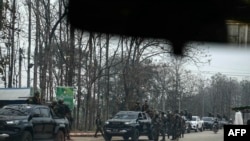 In this photo taken on Feb. 24, 2025 members of the Karen Border Guard Force (BGF) take part in a crackdown operation on illicit activity linked to scam centers in Myanmar's eastern Myawaddy township.