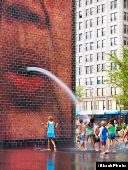 Children play in the Crown Fountain at Chicago's Millenium Park, 2010.