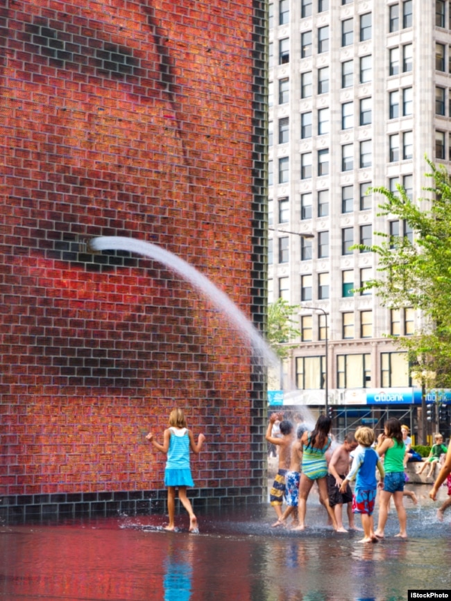 Children play in the Crown Fountain at Chicago's Millenium Park, 2010.