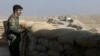 A militiaman of the Kurdistan Freedom Party, an Iranian Kurdish opposition group, looks over the sandbags at a section of the frontline near the Iraqi city of Kirkuk, Sept. 5, 2016.