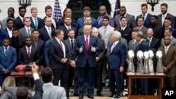  President Donald Trump stands with New England Patriots coach Bill Belichick, left, owner Robert Kraft, right, and team members during a ceremony on the South Lawn of the White House in Washington, April 19, 2017. Trump honored the team for their Super Bowl LI victory.