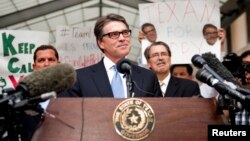 Texas Governor Rick Perry speaks after being booked at the Travis County courthouse in Austin, Aug. 19, 2014.