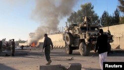FILE - Smoke bellows after a suicide car bomb blast attacked a military convoy in Lashkar Gah, Helmand province, Afghanistan, Nov. 15, 2015.