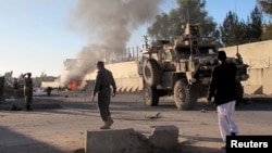 Smoke bellows after a suicide car bomb blast attacked a military convoy in Lashkar Gah, Helmand province, Afghanistan, Nov. 15, 2015.