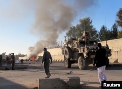 Smoke bellows after a suicide car bomb blast attacked a military convoy in Lashkar Gah, Helmand province, Afghanistan, Nov. 15, 2015.