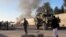 FILE - Smoke bellows after a suicide car bomb blast attacked a military convoy in Lashkar Gah, Helmand province, Afghanistan, Nov. 15, 2015.