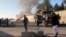 FILE - Smoke bellows after a suicide car bomb blast attacked a military convoy in Lashkar Gah, Helmand province, Afghanistan, Nov. 15, 2015.