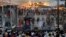 Kashmiri residents watch as firefighters try to extinguish a fire at the nearly 200-years-old Sheikh Abdul Qadir Jeelani Shrine, popularly known as Ghaus-e-Azam, or Dastgeer Sahab, in downtown Srinagar, India, June 25, 2012.