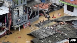 An aerial photo shows rescue teams evacuating people whose homes have been flooded in Pasar Minggu district in Jakarta on March 4, 2025.