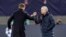 Tottenham's manager Jose Mourinho, right, and Leipzig's head coach Julian Nagelsmann touch their forearms instead of shaking hands due to the coronavirus after the Champions League round of 16, 2nd leg soccer match between RB Leipzig and Tottenham.