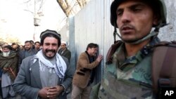 Afghans cry after an attack on a military hospital in Kabul, Afghanistan, March 8, 2017. 