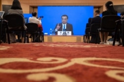 Chinese Premier Li Keqiang speaks on screen during a press conference by video conferencing at the end of the National People's Congress in Beijing, May 28, 2020.
