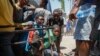 Sejumlah warga Haiti berlindung setelah mendengar suara tembakan di sebuah sekolah yang menjadi tempat pengungsian para warga di Port-au-Prince, Haiti, pada 22 Maret 2024. (Foto: AP/Odelyn Joseph)
