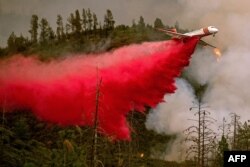An air tanker drops retardant while battling the Ferguson fire in Stanislaus National Forest, near Yosemite National Park, California, July 21, 2018.