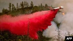 FILE - An air tanker drops retardant while battling the Ferguson fire in Stanislaus National Forest, near Yosemite National Park, California, July 21, 2018.