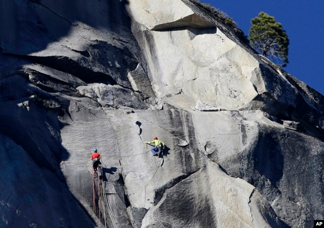 Kevin Jorgeson, left, and Tommy Caldwell climb El Capitan, Wednesday, Jan. 14, 2015, as seen from the valley floor in Yosemite National Park