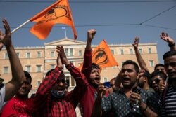 Migrants living in Greece chant slogans during a rally in Athens, June 20, 2020. Hundreds of protesters marched against the possible discontinuation of a migrants' housing program which will leave thousands without a place to stay.