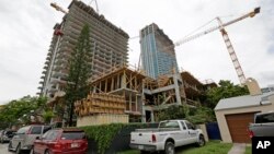 In this photo taken July 22, 2014, a 36 floor high rise condominium is under construction in Miami. 