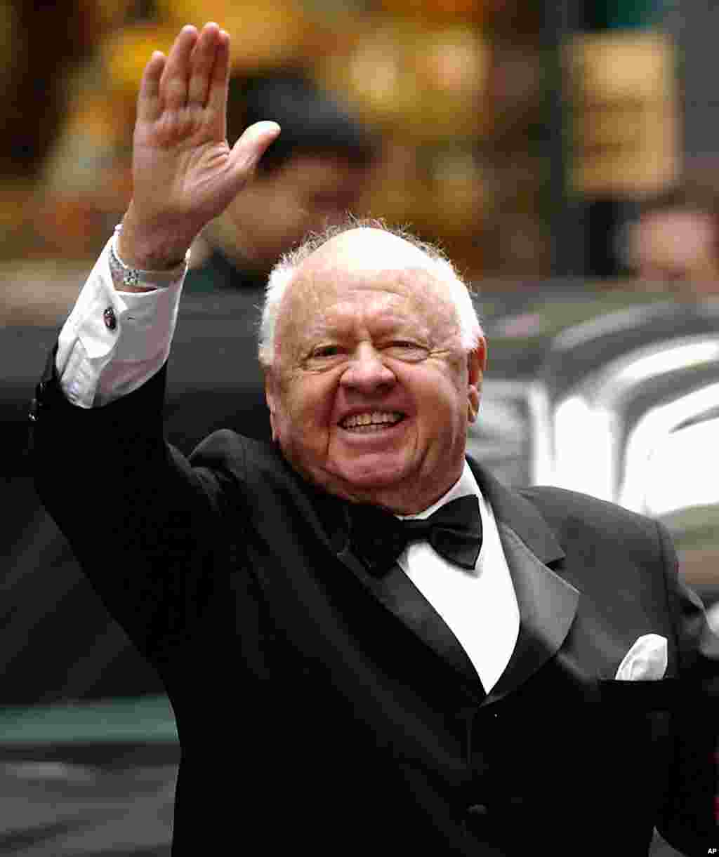 Actor Mickey Rooney waves to admirers as he departs the Regent Wall Street Hotel in New York. He was Hollywood&#39;s top box-office draw in the late 1930s-1940s. He died Sunday, April 6, 2014, at his North Hollywood home at age 93.