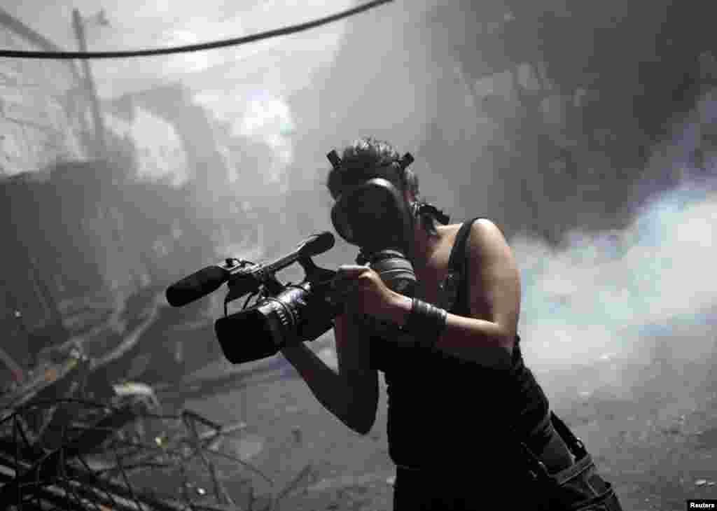 A member of the local media records a fire at the Comayaguela market in Tegucigalpa, Honduras, February 18, 2012. (Reuters)