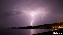 FILE - Lightning strikes are seen above Villarrica lake, in Villarrica, Chile, December 7, 2021. (REUTERS/Cristobal Saavedra Escobar) 