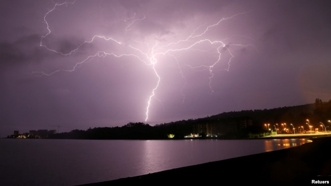 Lightning strikes are seen above Villarrica lake, in Villarrica, Chile, December 7, 2021. (REUTERS/Cristobal Saavedra Escobar)