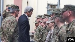 FILE - Secretary of State Kerry greets U.S. troops outside Resolute Support Headquarters following a meeting with General "Mick" Nicholson, commander of U.S. forces in Afghanistan, April 9, 2016. (P. Dockins/VOA)