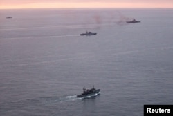 A photo taken from a Norwegian surveillance aircraft shows a group of Russian navy ships in international waters off the coast of northern Norway, Oct. 17, 2016.