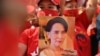 A Myanmar migrant holds up an image of Aung San Suu Kyi during a demonstration outside the Myanmar embassy in Bangkok on February 1, 2021, after Myanmar's military detained the country's de facto leader Suu Kyi and the country's president in a coup.