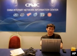 FILE - An employee of the China Internet Network Information Center is seen during a meeting of the Internet Corporation for Assigned Names and Numbers (ICANN) in Paris, June 26, 2008. China recently proposed companies register Internet domain names dome
