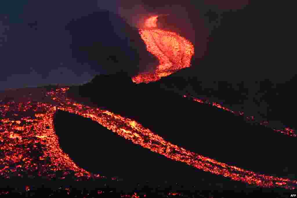 Lava flows from Guatemala&#39;s Pacaya Volcano, as seen from Cerro Chino in San Vicente Pacaya municipality, south of Guatemala City, May 5, 2021.