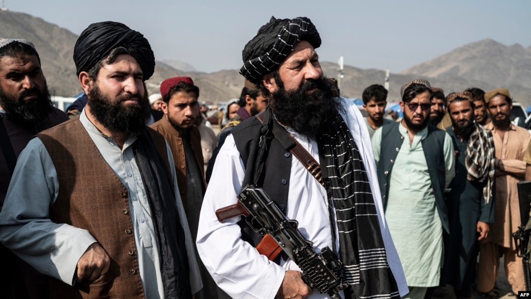 FILE - Afghanistan's minister for refugees Khalil Ur-Rahman Haqqani, center, looks on as he arrives to inspect a refugee camp near the Afghanistan-Pakistan Torkham border in Nangarhar province on Nov. 2, 2023.