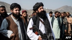 FILE - Afghanistan's minister for refugees Khalil Ur-Rahman Haqqani, center, looks on as he arrives to inspect a refugee camp near the Afghanistan-Pakistan Torkham border in Nangarhar province on Nov. 2, 2023.