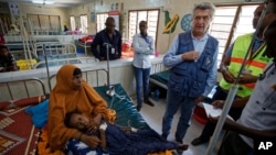 U.N. refugee chief Filippo Grandi, center-right, visits a hospital as he tours Dadaab refugee camp, Dec. 19, 2017.