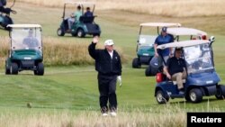 U.S. President Donald Trump gestures as he walks on the course of his golf resort, in Turnberry, Scotland July 14, 2018.