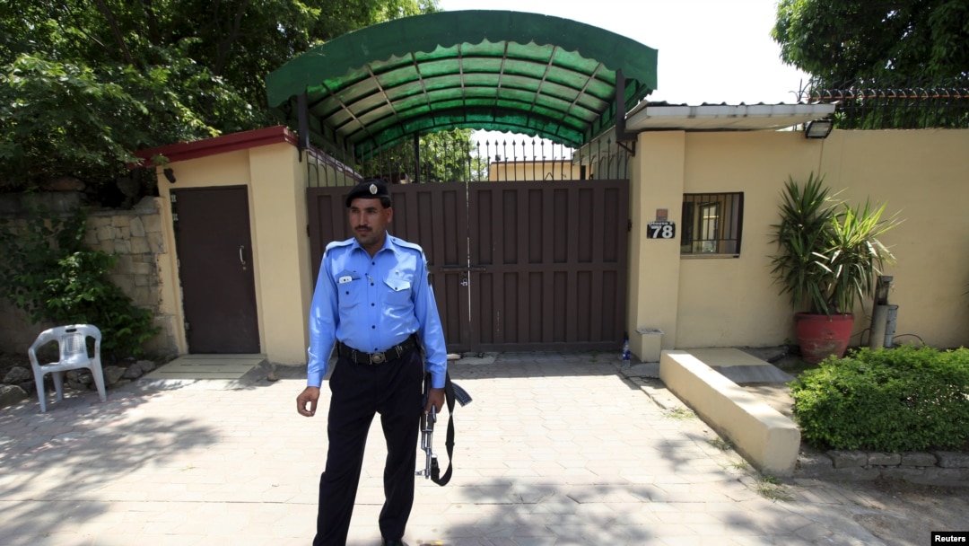 A policeman stands guard outside the Save the Children charity's office in Islamabad, Pakistan, June 12, 2015.