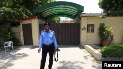 A policeman stands guard outside the Save the Children charity's office in Islamabad, Pakistan, June 12, 2015.