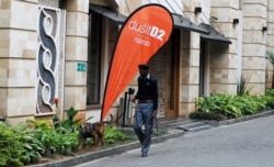 FILE - A security officer and guard dog patrol the DusitD2 Hotel during its reopening after its closure in January of 2019 following an attack by al-Shabab militants, in Nairobi, Kenya, July 31, 2019.