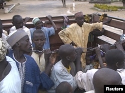 Former Nigerian hostages held by Boko Haram who were freed by the Cameroonian military arrive in Maroua, Cameroon, in this still image taken from a Dec. 5, 2015 video footage.