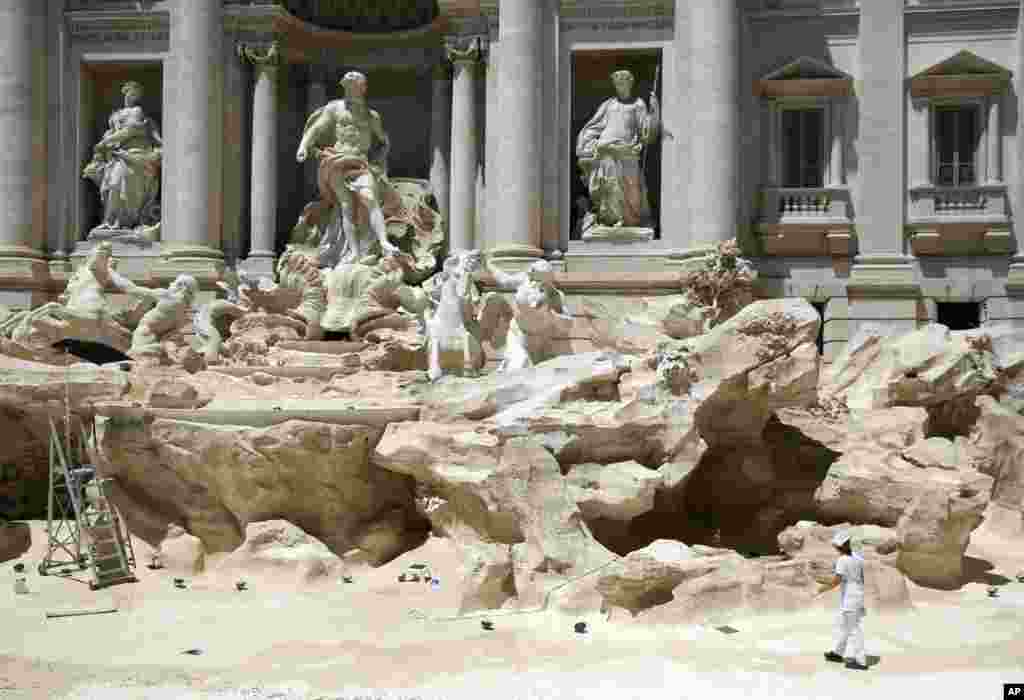 Workers clean the inside of the Trevi fountain during a one-day routine maintenance, in Rome, Italy.