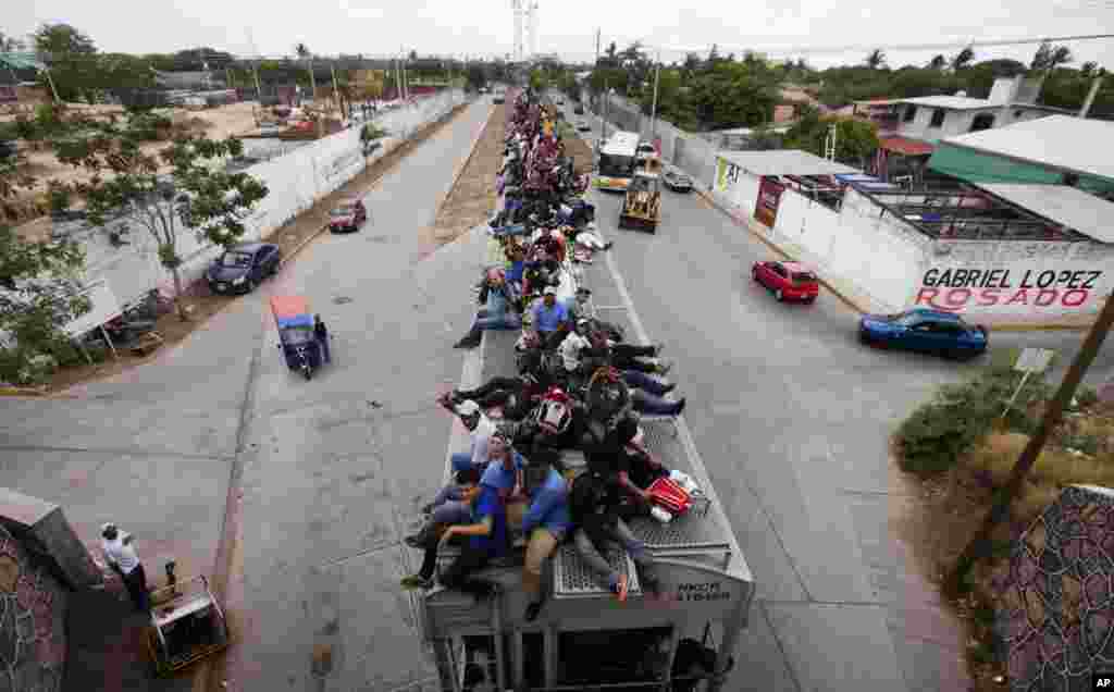 Migrants ride on top of a northern bound train toward the U.S.-Mexico border in Juchitan, southern Mexico, Apr. 29, 2013. Migrants crossing Mexico to get to the U.S. have increasingly become targets of criminal gangs who kidnap them to obtain ransom money.
