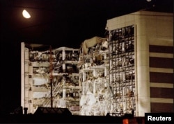 An April 21, 1995 file photo shows the moon over the wreckage of the Alfred P. Murrah Federal Building in downtown Oklahoma City, Oklahoma.