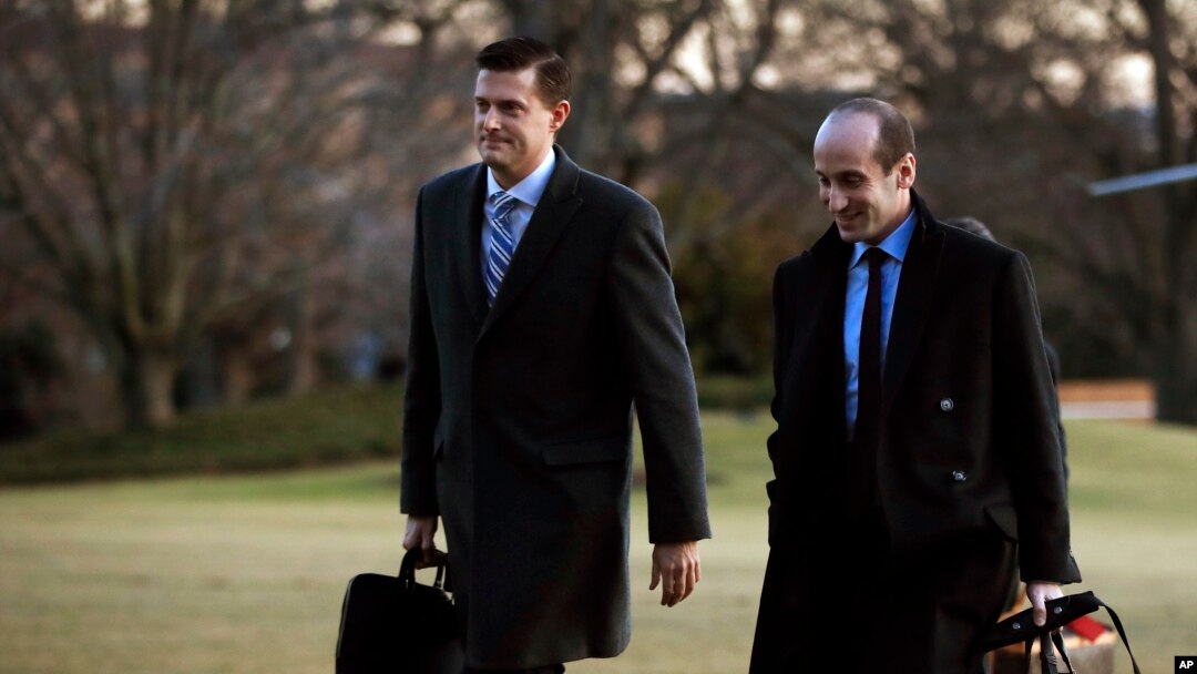 White House staff secretary Rob Porter, left, walks with White House senior adviser Stephen Miller from Marine One across the South Lawn of the White House in Washington, Feb. 5, 2018.